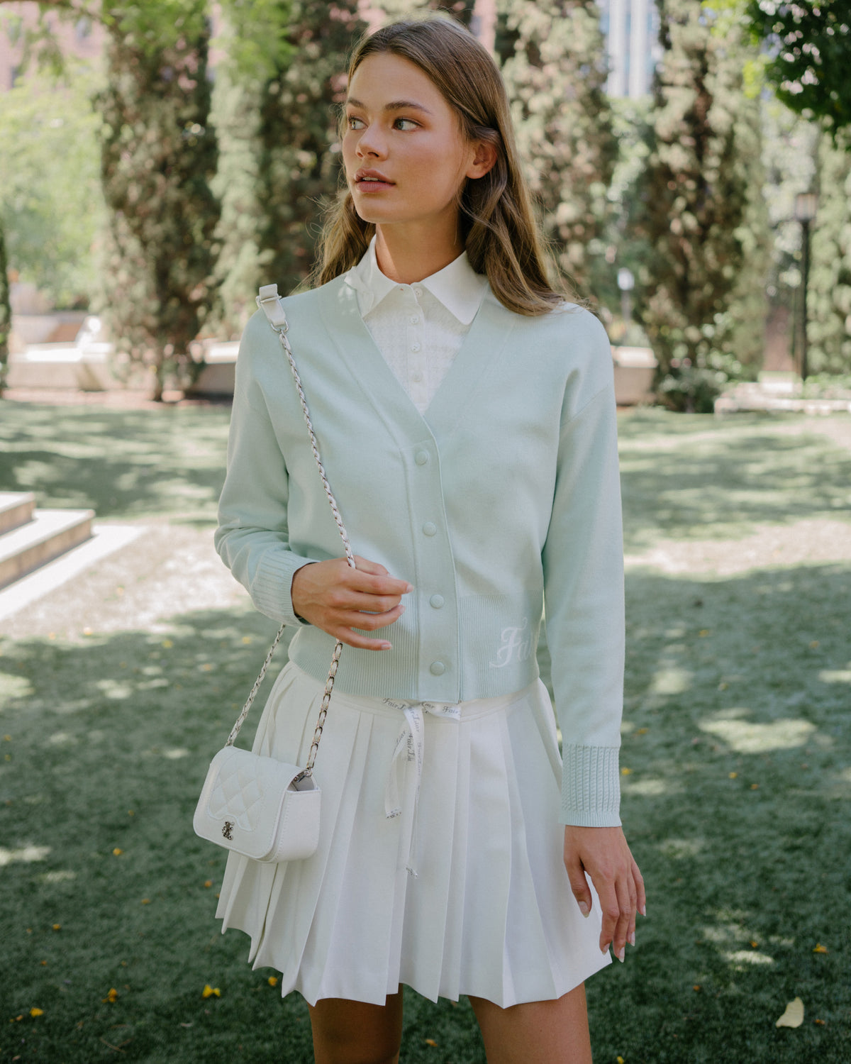 Women's white polo blouse with bow detail by Fairliar
