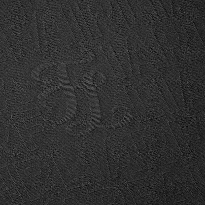 Women's black mock neck top by Fairliar with textured monogram detail
